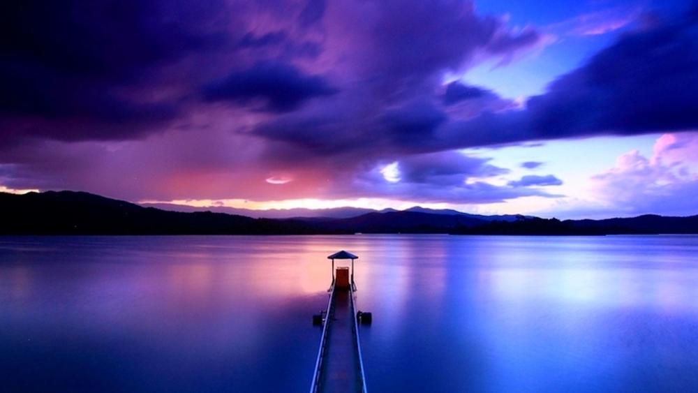 Pier Into Purple Dusk Over a Tranquil Lake wallpaper