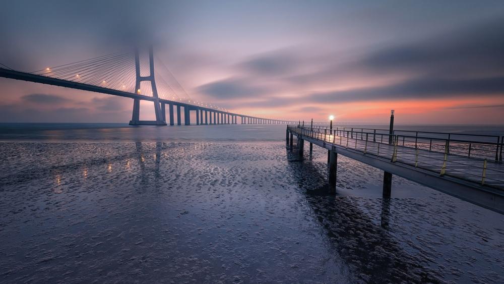 Vasco da Gama Bridge at Dawn Over Lisbon Waters wallpaper