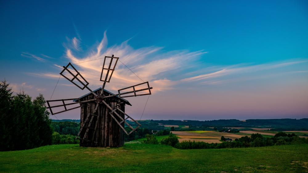 Hilltop Wooden Windmill Over Quiet Grasslands at Dusk in 4K wallpaper