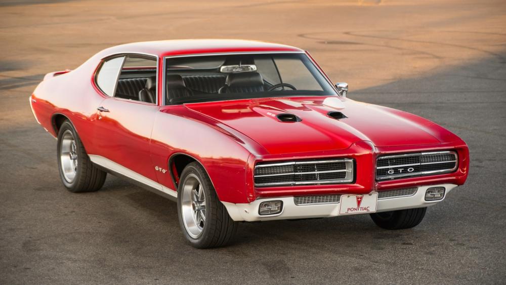 Red Pontiac GTO Muscle Car in Golden Hour Shine wallpaper