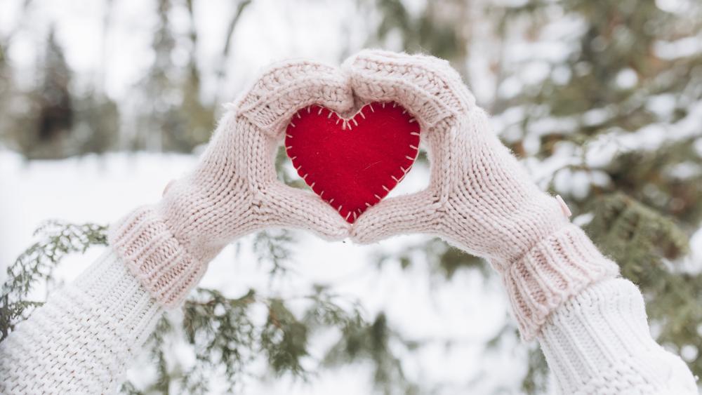 Warm Winter Love Hands Framing a Bright Red Heart wallpaper