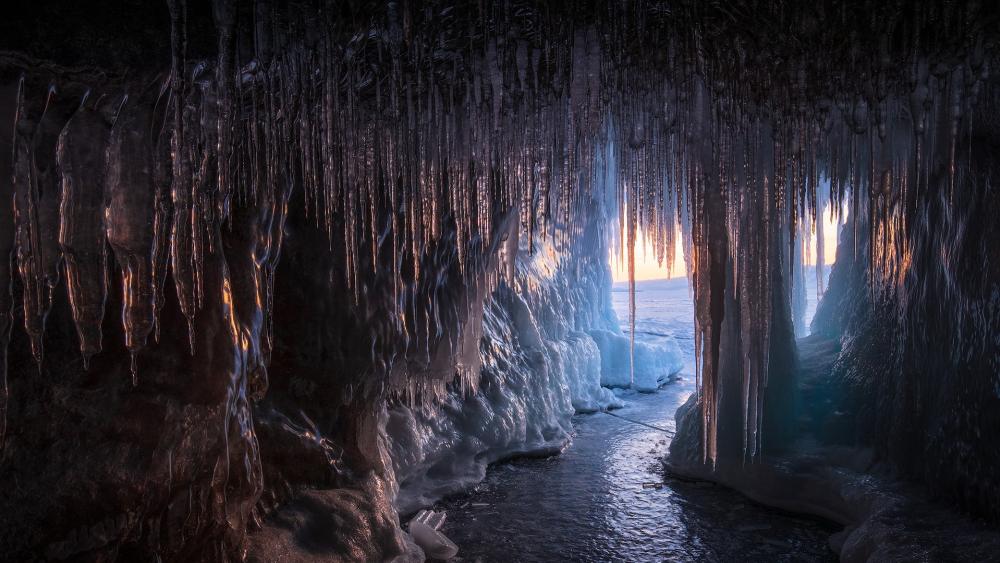 Sunlit Icicle Cave on Frozen Lake Baikal Shoreline wallpaper