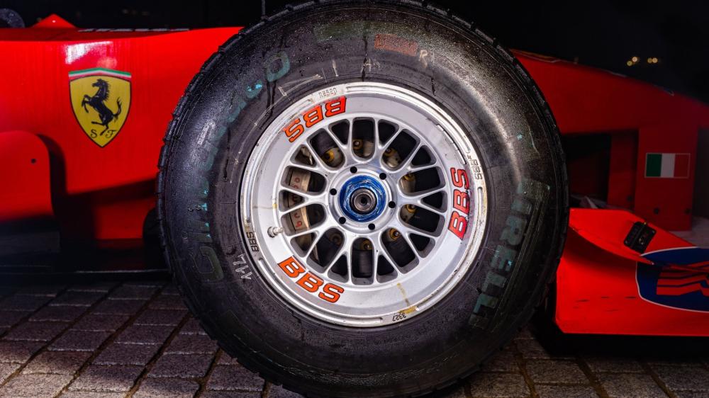 Formula Racing Close Up Tire and Wheel Under Pit Lights wallpaper