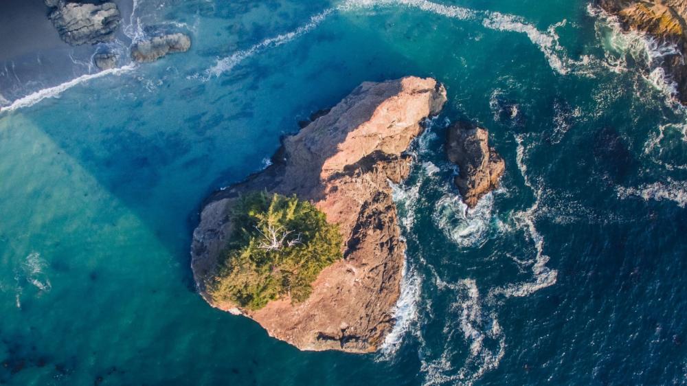 Aerial Ocean Swell Around Lone Rock Island wallpaper