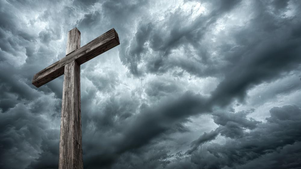 Weathered Cross Against Stormy Heaven in Cinematic Nature Light wallpaper