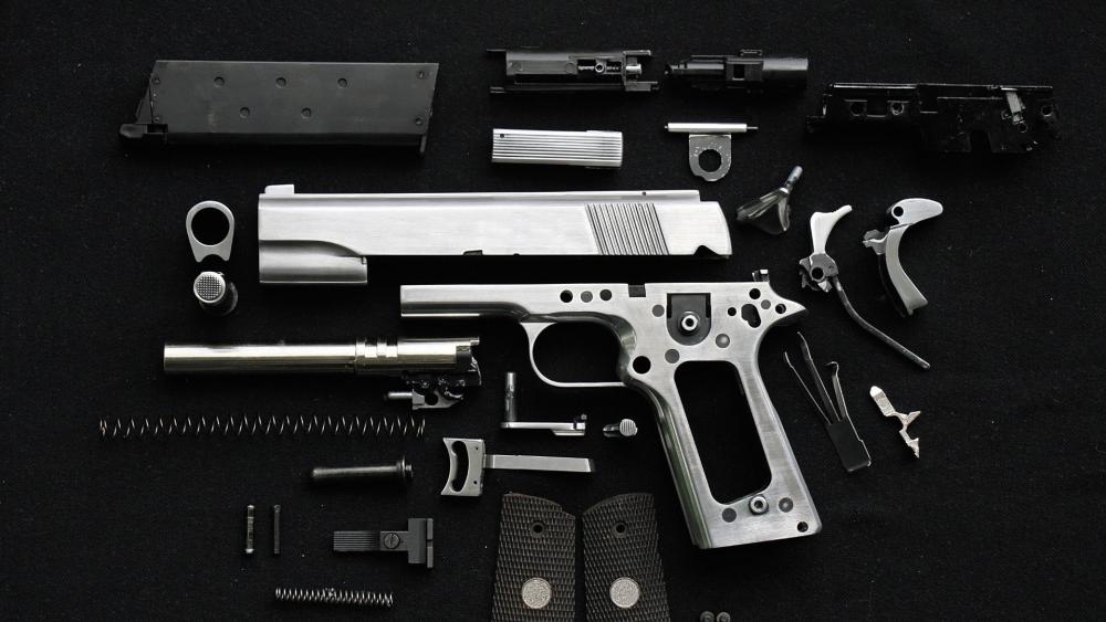 Disassembled Tactical Handgun Parts on Dark Workbench Flat Lay wallpaper