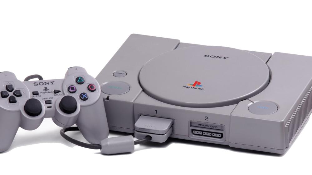 Classic PlayStation Console and Controller on Clean White Background wallpaper