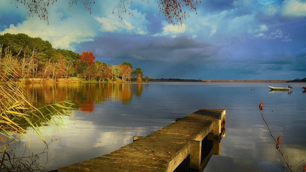 Autumn Reflections on the Pier at Lac de Lacanau France wallpaper