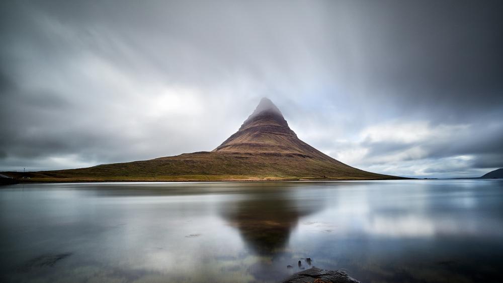 Misty Kirkjufell Reflection in Moody Icelandic Stillness wallpaper