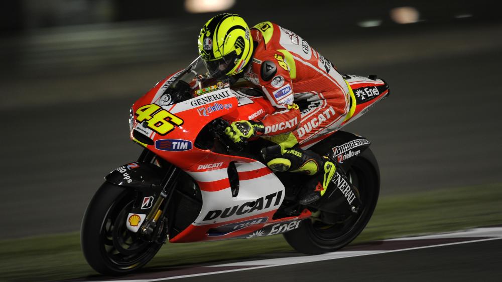 Ducati MotoGP Racer Leaning Hard Through Night Circuit wallpaper