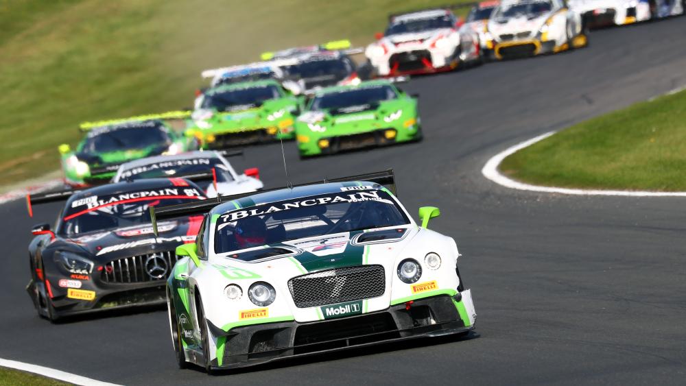 High Speed GT Racing Pack Charging Through a Sweeping Corner wallpaper