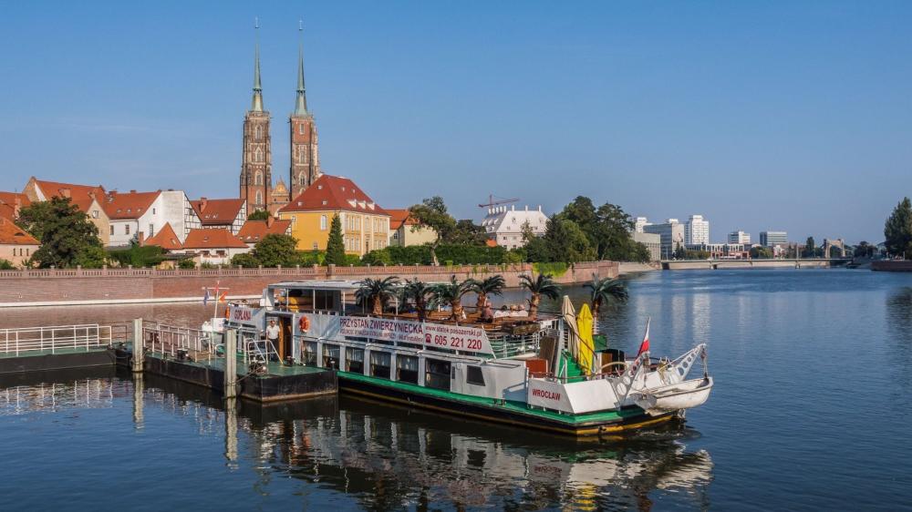 Ferry on the Oder River beneath Wrocław Cathedral spires wallpaper