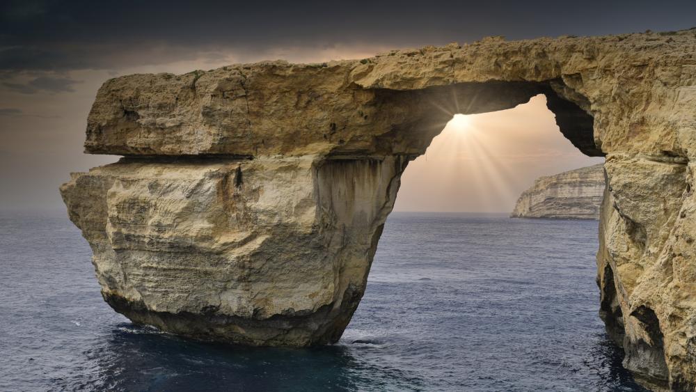Sunbeams Through Malta’s Azure Window Natural Arch Over the Sea wallpaper
