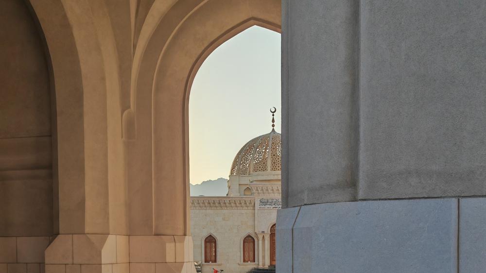 Sunlit Palace Dome Framed by Arches in Muscat Oman wallpaper