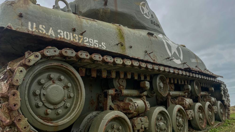 Weathered Sherman Tank Tracks Under Brooding Skies in 4K wallpaper