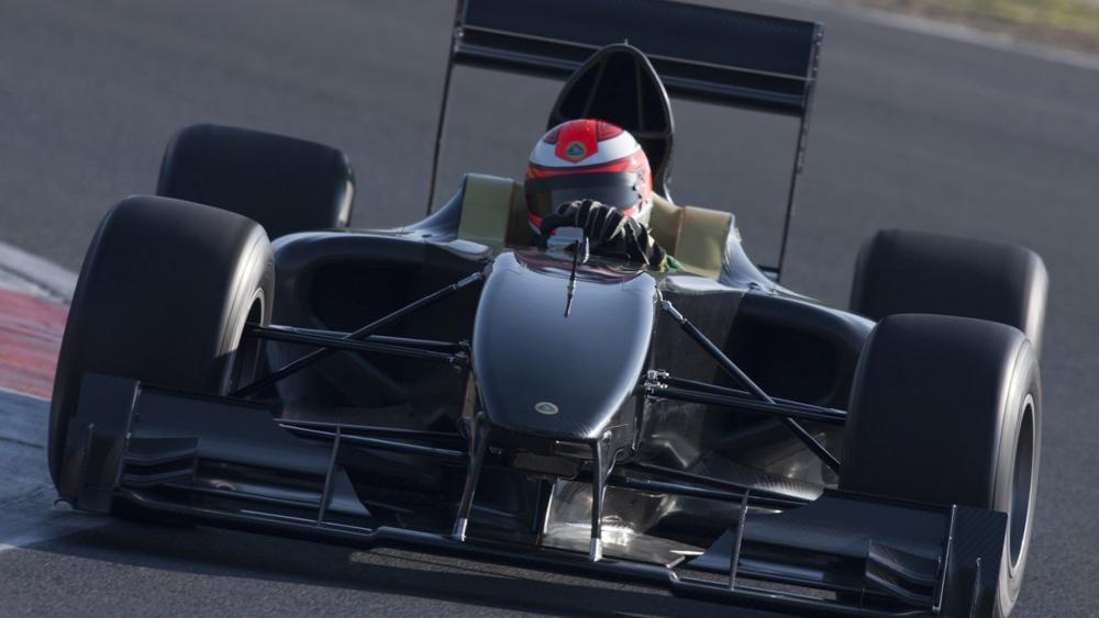 Head On Formula One Racing Car Charging Through The Corner wallpaper