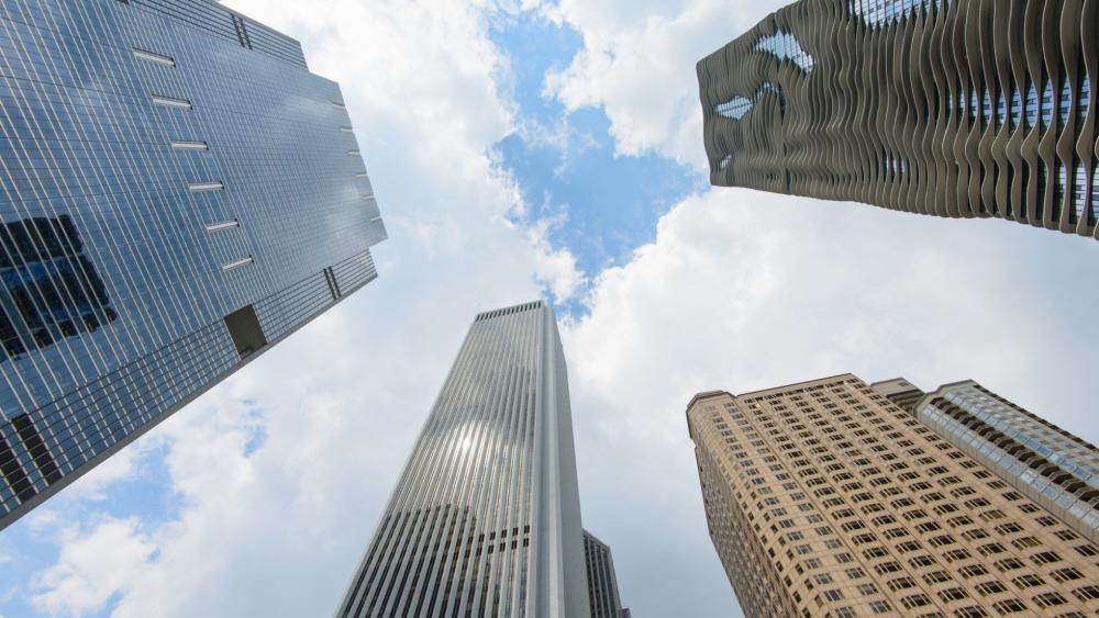 Skyward Perspective Among Daytime Skyscrapers wallpaper
