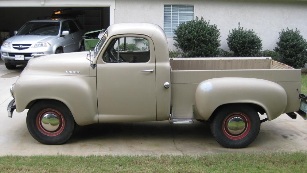 Vintage Beige Pickup Truck Parked in a Quiet Suburban Driveway wallpaper