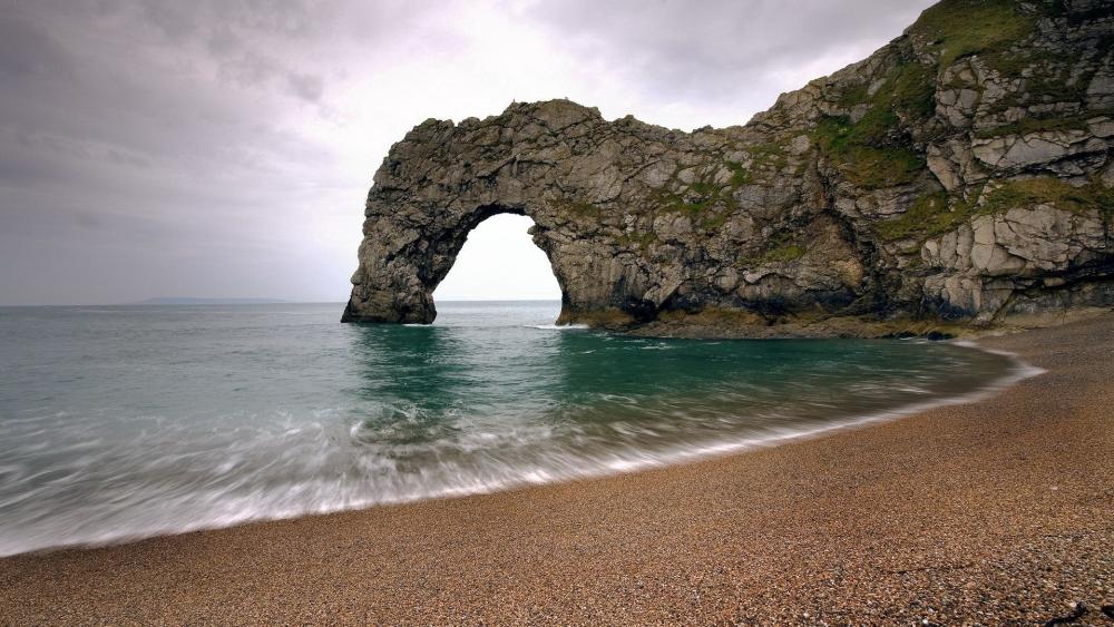 Durdle Door Natural Arch Over Calm Jurassic Coast Waters wallpaper