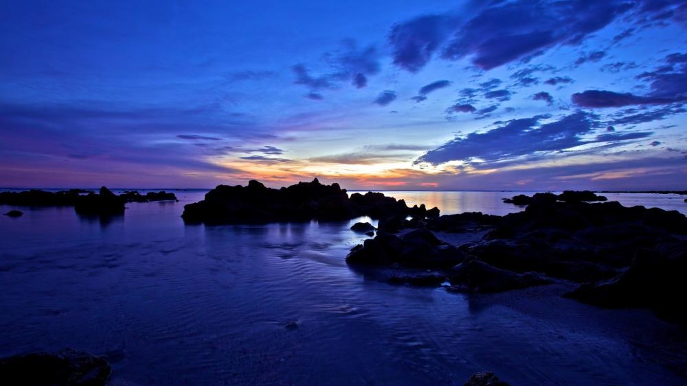 Blue Hour Seascape with Silhouetted Rocks and Calm Reflections wallpaper
