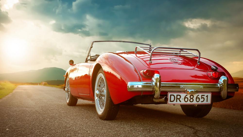 Crimson MG Roadster on an Open Road at Golden Hour wallpaper