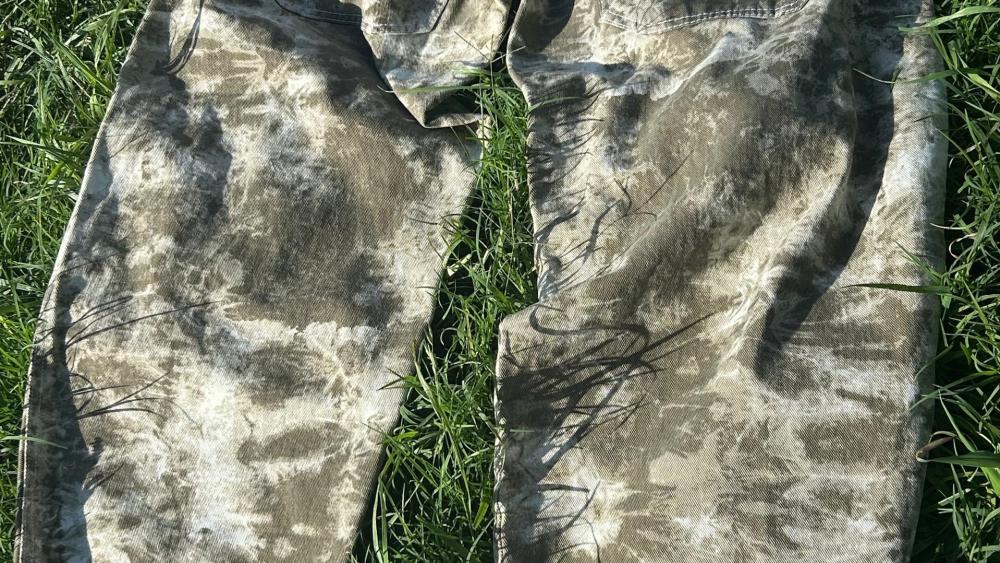 Sunlit Tie Dyed Denim on Grass Abstract Texture Study wallpaper