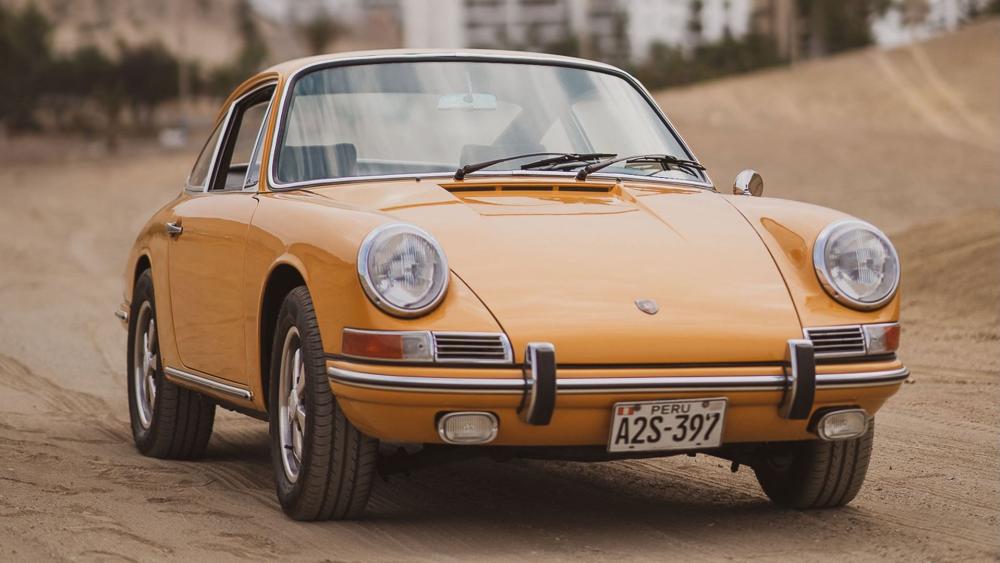 Golden Vintage Porsche 911 Classic Elegance on Sandy Road wallpaper
