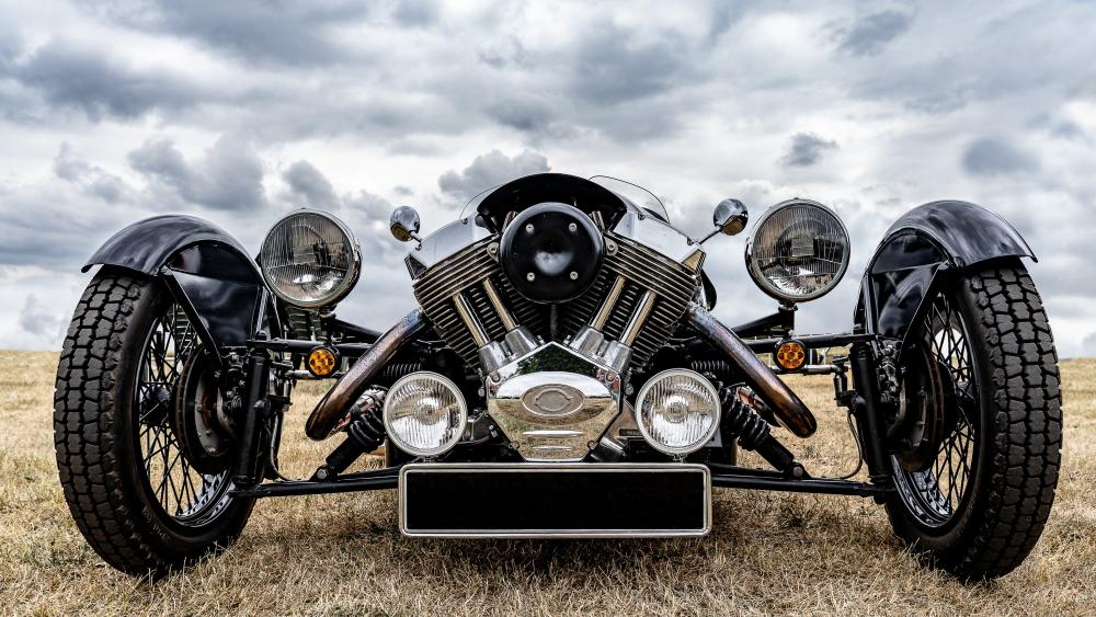 Morgan 3 Wheeler Front View Under Dramatic Cloudy Skies wallpaper
