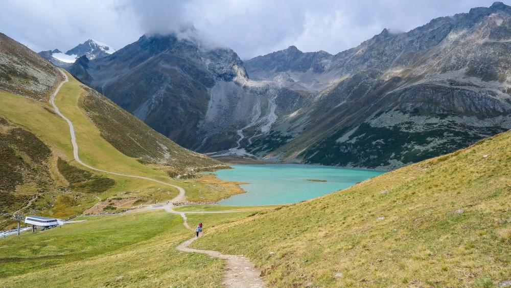 Misty Peaks Above Rifflsee Turquoise Mountain Lake in Austria wallpaper