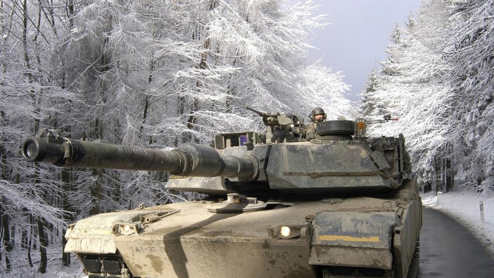 Winter Armored Patrol Tank Advancing Through Frosted Forest Road wallpaper
