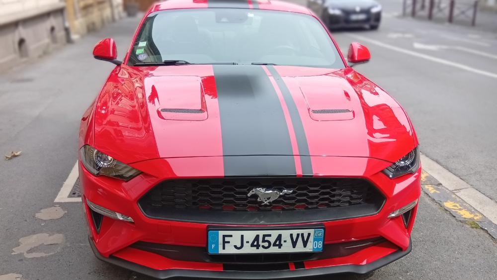 Red Ford Mustang with Racing Stripes Parked Street Front View wallpaper