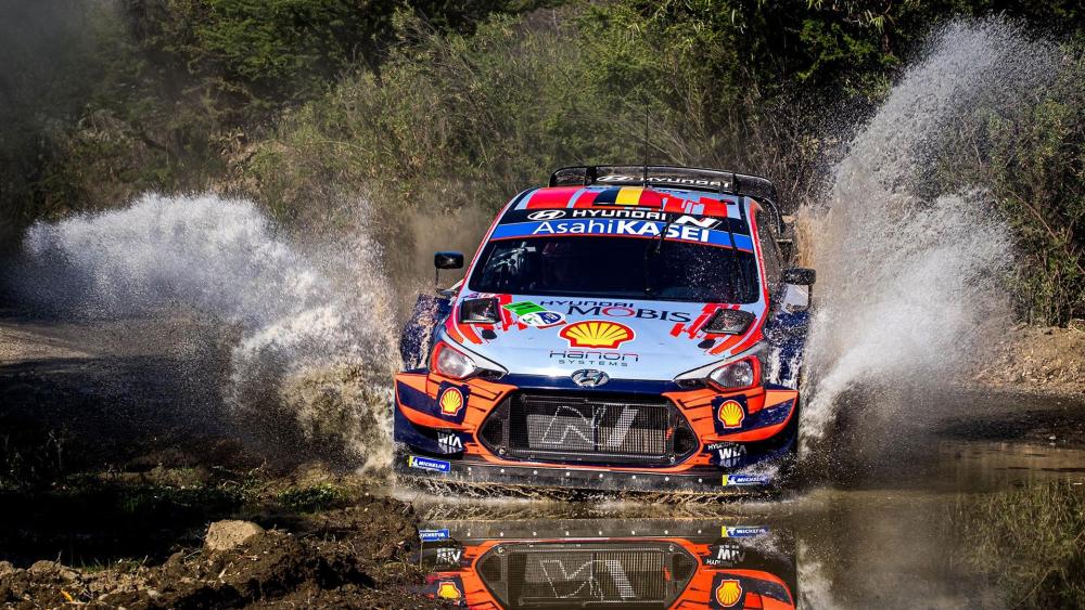 Hyundai WRC Rally Car Charging Through Water Splash at Full Speed wallpaper