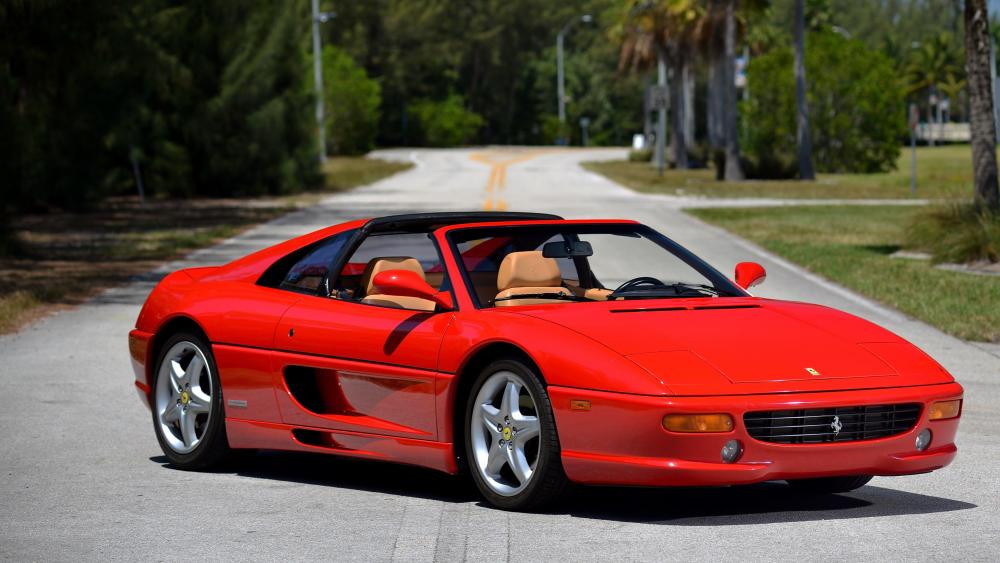 Sunlit Red Ferrari F355 GTS Targa Cruising in 90s Style wallpaper