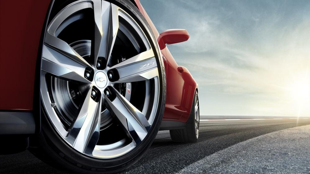 Chevrolet Sports Car Wheel Closeup on Open Road Horizon wallpaper