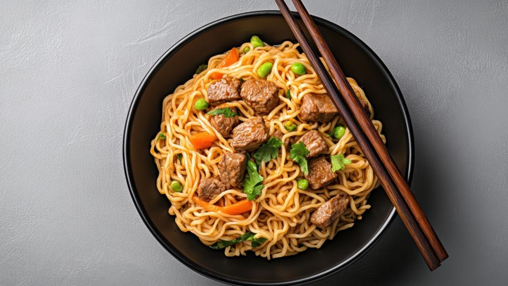 Savory Beef Noodles in Black Bowl with Chopsticks 5K Wallpaper wallpaper