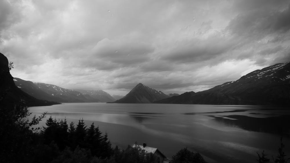 Storm Clouds Over a Silent Mountain Lake Panorama wallpaper