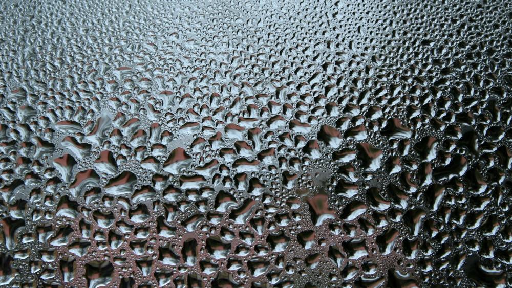 Liquid Silver Droplets in Abstract Metallic Ripple Field wallpaper
