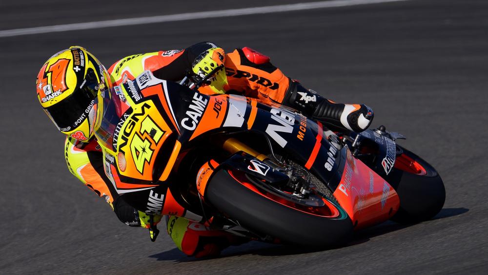 MotoGP Racer Leaning Into High Speed Corner wallpaper