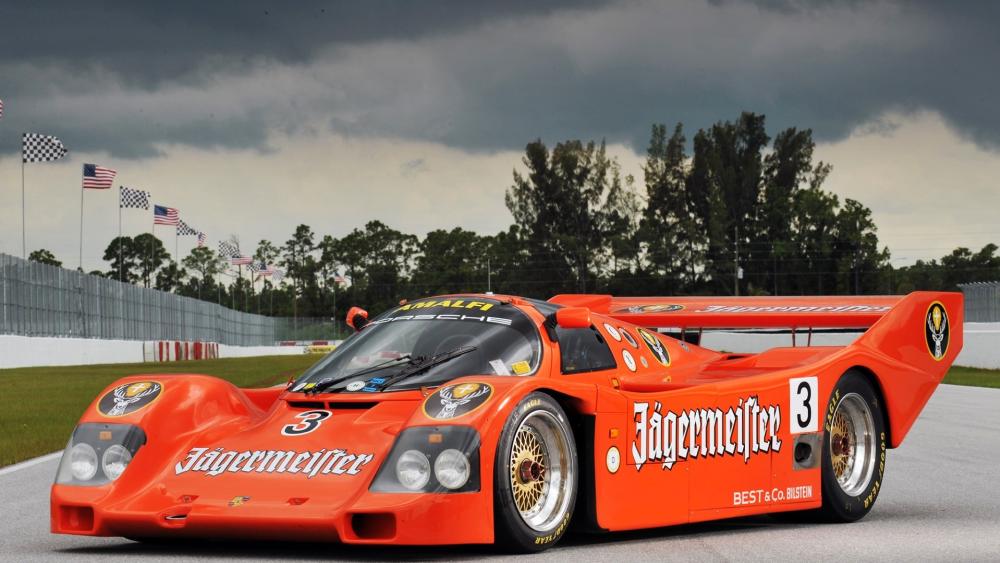 Orange Racing Beast on Stormy Track wallpaper