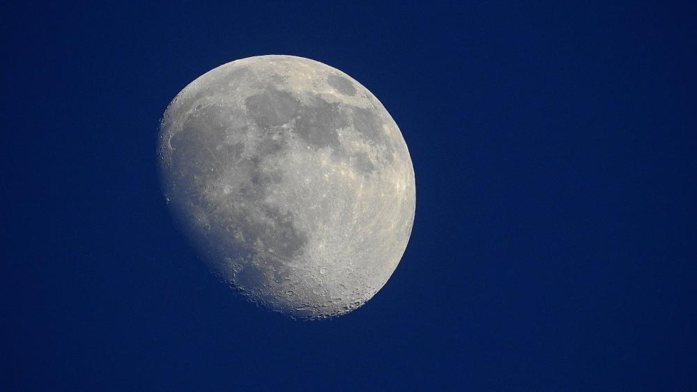 Luminous Moon Against Deep Blue Sky wallpaper