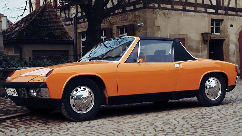 Classic Orange Porsche 914 on Cobblestone Street wallpaper