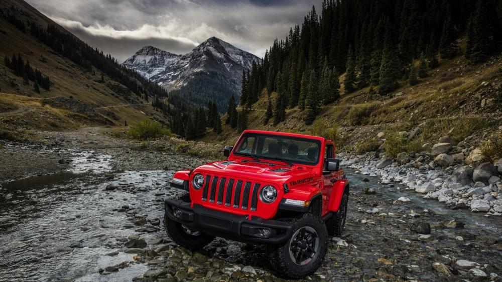 Red Jeep Wrangler in Rugged Mountain River Landscape wallpaper