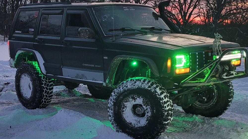 2000 Jeep Cherokee in the snow with green lights wallpaper