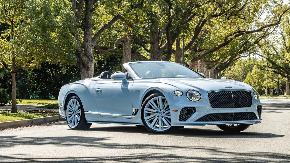 Elegant Bentley Convertible Under Sunlit Trees wallpaper
