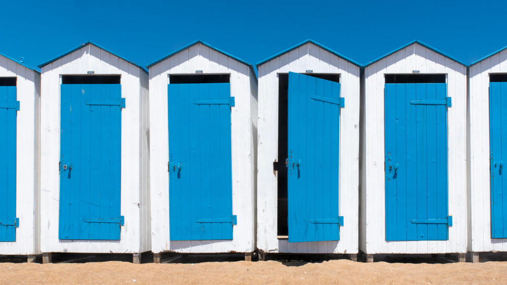 Coastal Beach Huts in Bright Blue wallpaper