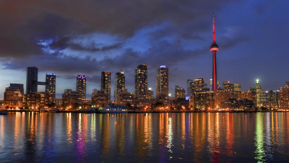 Toronto Skyline Glowing Over Lake Ontario wallpaper
