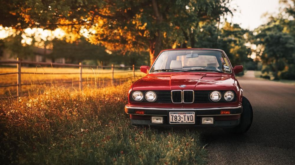 Classic Red BMW on Golden Country Road wallpaper