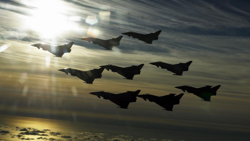 Golden Typhoon Squadron Over Cloudy Skies wallpaper