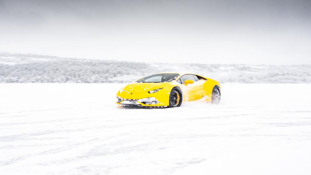 Yellow Lamborghini Huracan Racing Through Snowy Landscape wallpaper