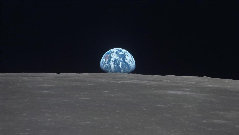 Earthrise Over Silent Lunar Horizon wallpaper